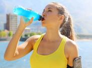 active_woman_drinking_electrolytes_in_water_bottle